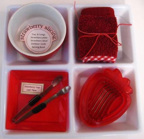 A tray showing strawberry slicing activity